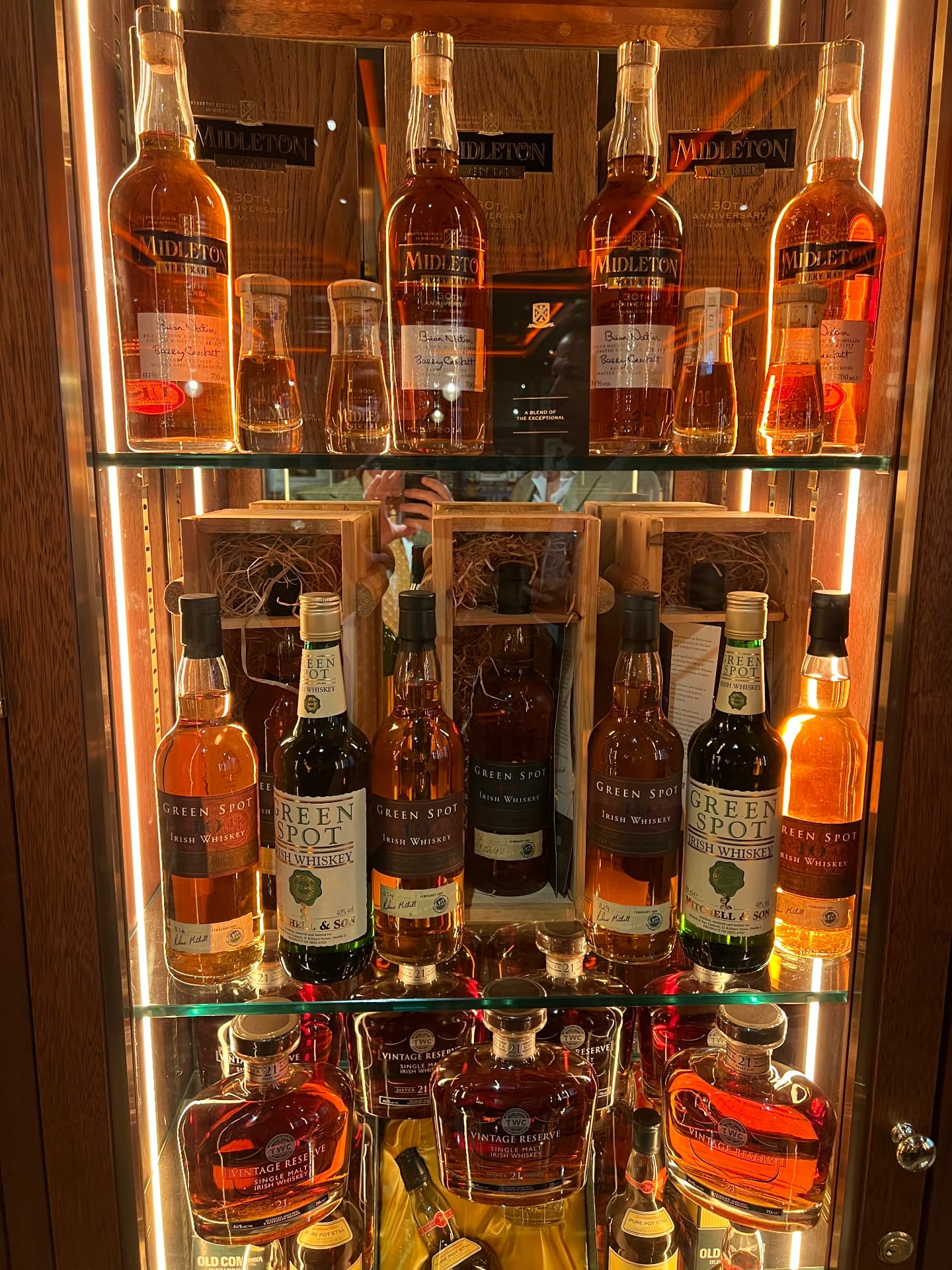 A lit cabinet of rare Irish whiskeys