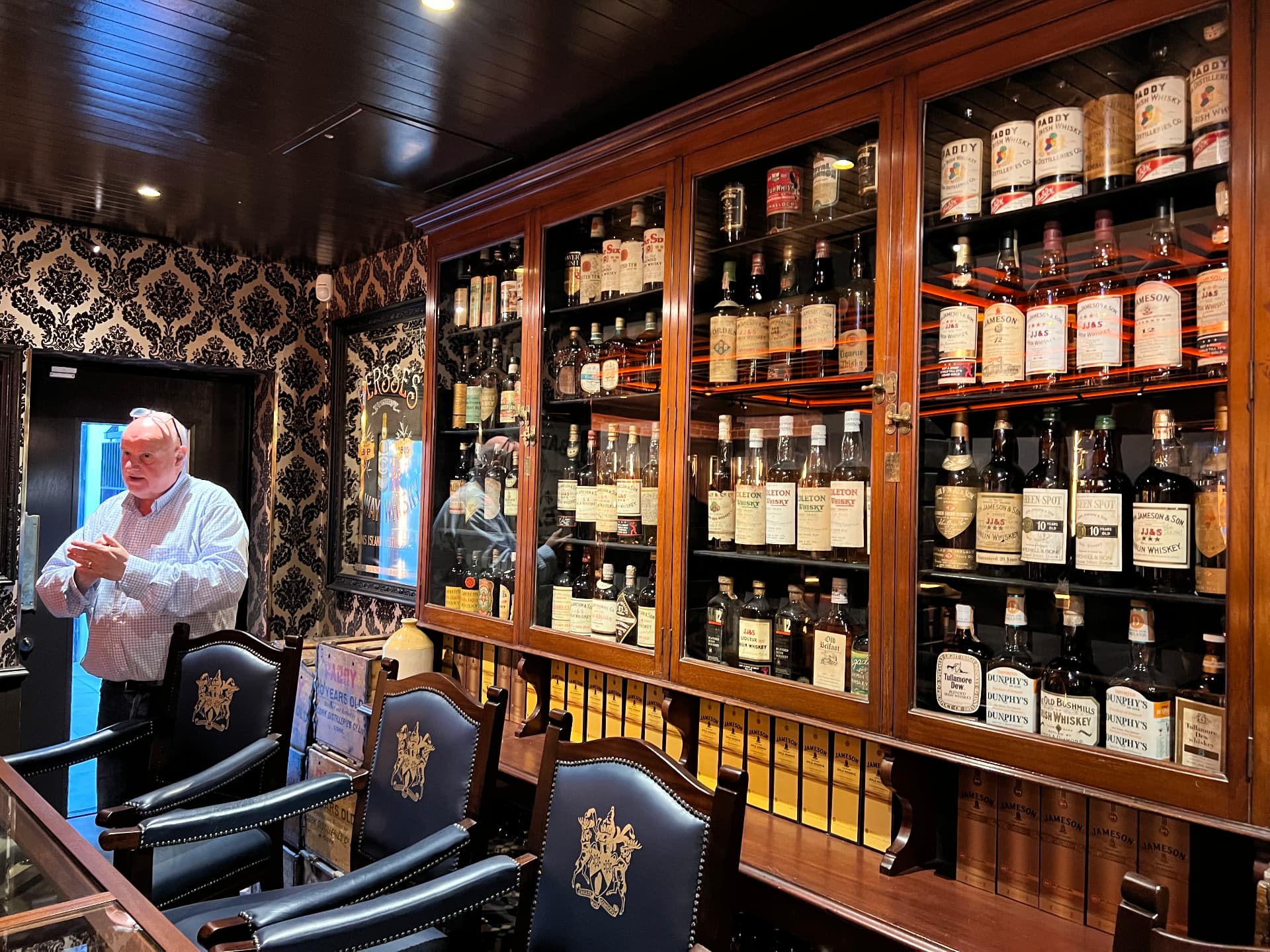 A wood-panelled room lined with cabinets of rare Irish whiskey