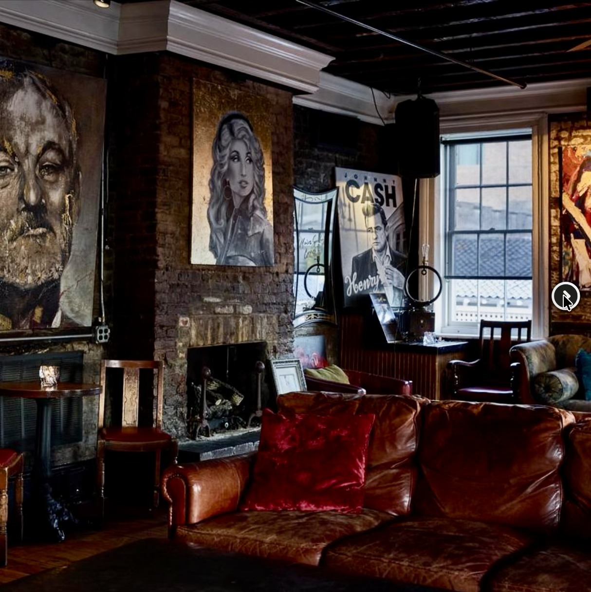 Leather sofas and portraits in the Whiskey Room at Henry's
